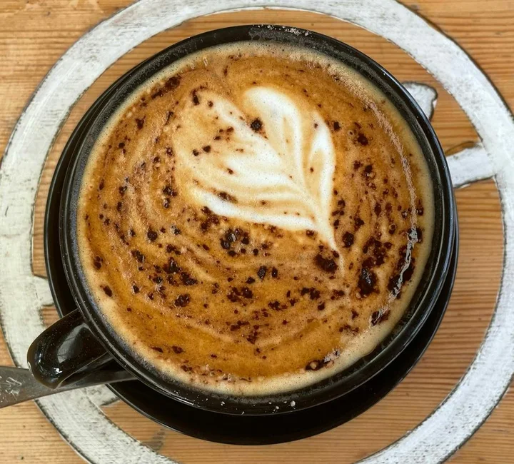 Coffee with leaf-shaped latte art served at Harry’s Place